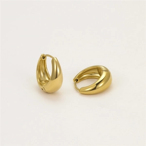 Detailed close-up of polished golden chunky water drop hoop earrings with secure closure