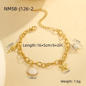 Detail shot of a gold chain bracelet featuring seashell, starfish, and conch charms