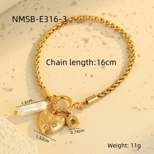 Close-up of gold woven chain bracelet with OT clasp and zircon heart pendant