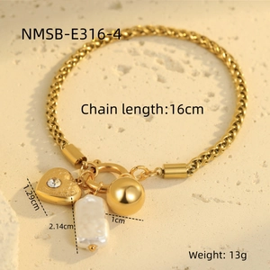 Detail of gold woven bracelet featuring heart charm, sphere and pearl pendant with dimensions