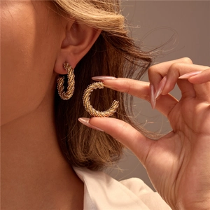 Modern two-tone twisted C-hoop earrings in 18k gold and silver stainless steel design