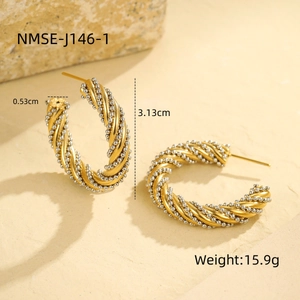 Detail view of two-tone twisted C-shape earrings with size and weight specifications