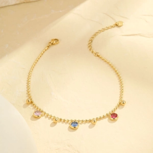 Gold beaded multi-layer anklet with pink, blue and red gemstone pendants for women
