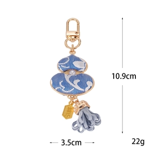 Blue and white floral fabric gourd keychain with gold clasp and leather tassel