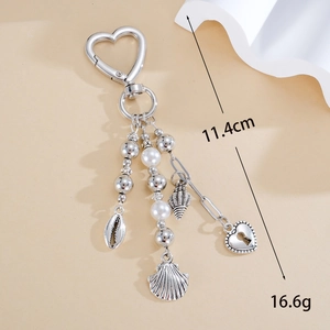 Silver ocean style heart keychain with pearls, seashells, and heart lock pendant