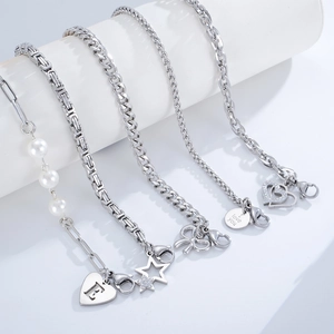 Creative stainless steel hand chains with star and heart charms on white display