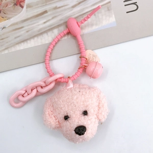 Detail showing pink plush teddy dog charm with bell, heart tag and silicone strap
