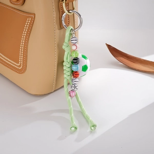Handwoven green nylon rope sports bag charm with football and basketball beads