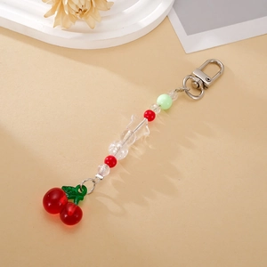 Detailed close-up of acrylic cherry keychain with a transparent star bead and metal clasp