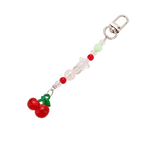 Acrylic cherry star keychain with red resin charms and colorful beaded chain on white