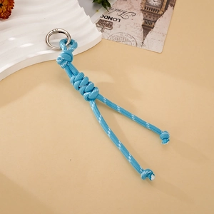 Detail of hand-woven blue nylon paracord keychain with a silver metal spring ring