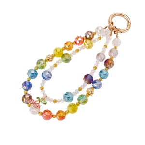 Rainbow beaded phone charm with double chains and a gold cherry pendant on white background