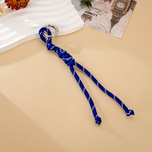 Close-up of a hand-woven navy blue nylon cord with silver spring buckle and knot detail