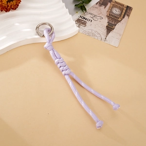 Close-up of handmade lavender nylon braided rope charm with silver spring metal ring