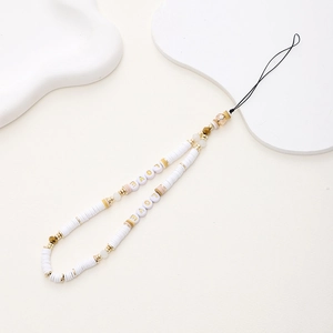 Detail of handmade LOVE beaded phone strap with white heishi clay beads and gold accents
