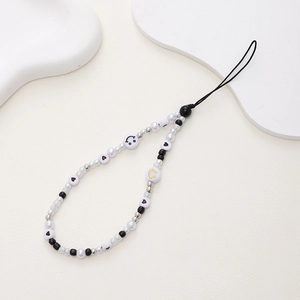 Handmade beaded phone strap with white pearls and black heart smiley face charms
