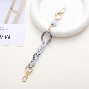 Detail view of acrylic marble chain with golden lobster clasps for bags and phone cases