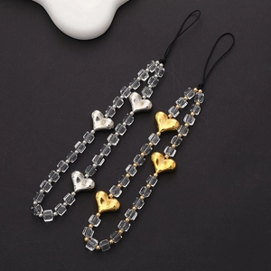 Close-up of gold and silver beaded phone lanyards with crystal beads and heart charms