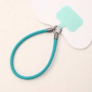 Detail of mint green leather phone wrist strap with durable metal ring and matching gasket