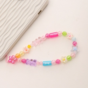 Detail of colorful acrylic beaded phone strap with smile, hug text and flower beads