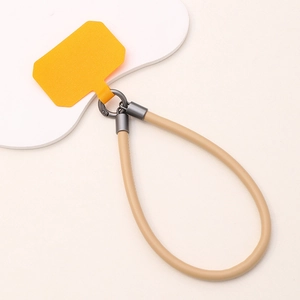 Short leather phone wrist strap with yellow patch and khaki cord on cloud board