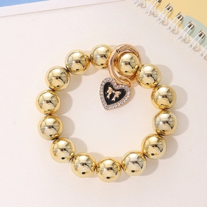 Bracelet à perles dorées avec pendentif coeur noir, noeud et cristaux scintillants