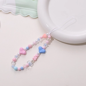 Close-up of colorful heart and bear beads for handmade mobile phone strap accessory
