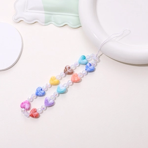 Detail of macaron heart beads and transparent round beads on a handmade phone strap