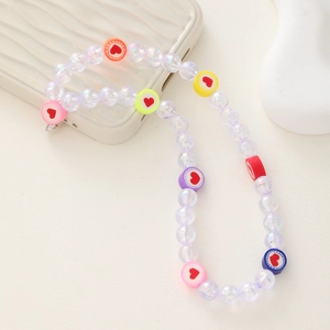 Handmade beaded phone charm with colorful hearts and iridescent stars on a white phone case