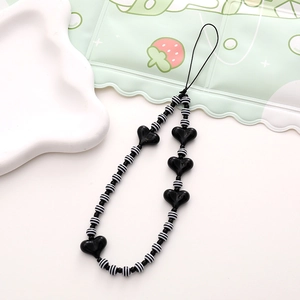 Short phone wrist strap with black and white striped beads and black heart accents