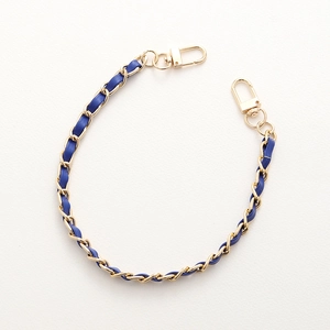 Handmade gold metal chain interwoven with blue leather and dual lobster clasps for bags