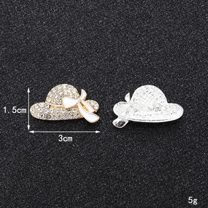 Golden hat-shaped charm with white crystals and bow, size 3x1.5cm for DIY accessories