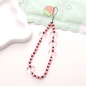 Close-up of pink and white striped beads with heart charms on a stylish phone wrist strap