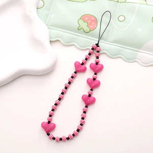 Detail showing pink heart beads and striped round beads on a handmade phone charm lanyard