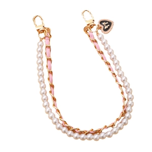 Pink woven chain and pearl phone strap with a heart-shaped bow pendant for women