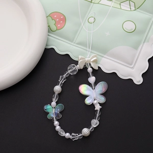 Detail of iridescent butterfly and white bow beaded phone charm with star shaped pearls