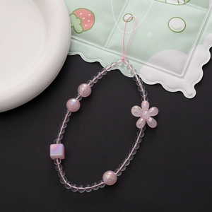 Detail of beaded phone strap with pink pearls, translucent beads and flower charm