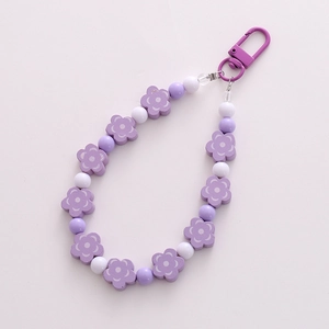Handmade purple and white beaded flower keychain with a metal lobster clasp