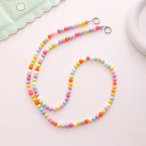 Detail showing colorful acrylic beads on a phone strap with silver metal ring clasps
