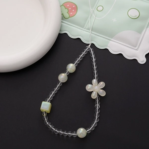 Close-up of handmade beaded phone strap with iridescent beads and flower charm