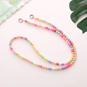 Detail of candy-colored acrylic beaded phone strap with silver round spring metal buckles