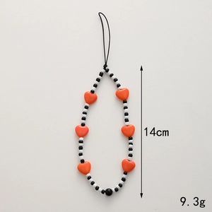 Beaded phone strap with orange wooden heart and black white beads, 14cm long
