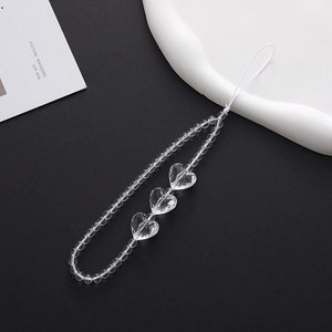 Detailed view of clear beaded phone strap with multi-faceted transparent heart-shaped beads