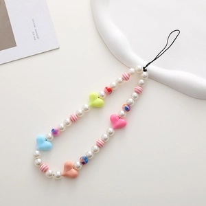 Close-up of colorful beaded phone strap with pearl beads and pastel heart pendants
