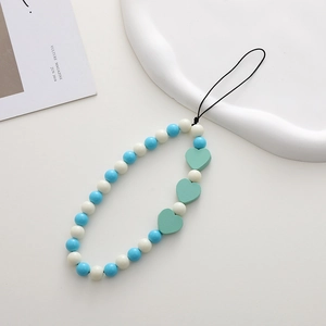 Detailed view of handmade beaded phone strap with blue white beads and green hearts