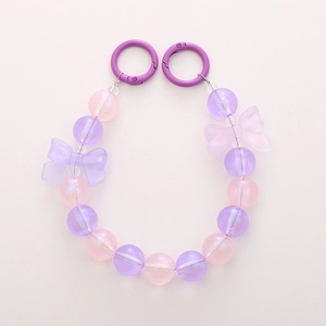 Pastel mermaid beaded phone chain with luminous bows and purple circular metal clasps