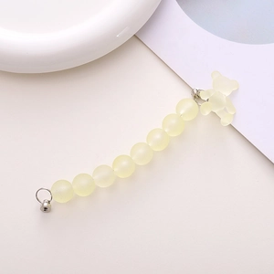 Close-up of matte yellow beaded phone strap with a translucent frosted bear charm