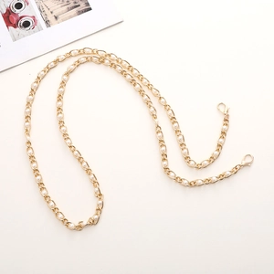 Detail of elegant gold metal chain strap with white pearls and lobster clasps