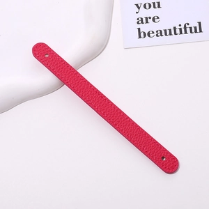 Detailed macro view of rose red lychee grain PU leather wrist strap with fine stitching