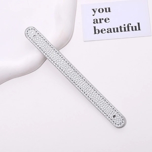 Detail of silver lychee grain PU leather wrist strap with reinforced stitching and mounting holes